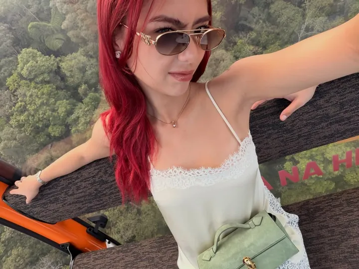 Kali with red hair in her photography studio
