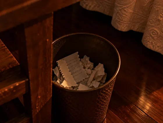 Pages of handwriting on a wooden desk.